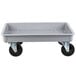 A gray fiberglass dough proofing box dolly with black wheels.