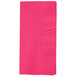 A close-up of a hot magenta pink Creative Converting paper dinner napkin.