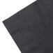 A pack of black Creative Converting luncheon napkins on a white surface.