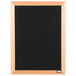 A black felt Aarco open face message board with a wooden frame.