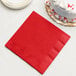 A Classic Red 3-ply paper dinner napkin next to a white cake.