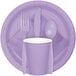 A purple paper plate with a fork, spoon, and knife on a purple Creative Converting Luscious Lavender paper napkin.