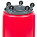 A red barrel with wheels.