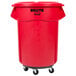 A red Rubbermaid BRUTE 55 gallon plastic container with wheels and a lid.