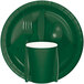 A green plate with a fork and spoon on a green Creative Converting luncheon napkin.