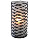 A close-up of a black wire mesh candle holder with a lit candle inside.