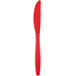 A red plastic knife with a white background.