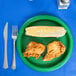 A Creative Converting emerald green paper plate with food on it and a fork.