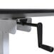 A black and white Luxor stand up desk with a black handle.