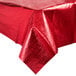 A red Creative Converting metallic plastic table cover on a table with a white background.