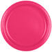 A close-up of a Creative Converting hot magenta pink paper plate with a curved edge.