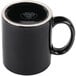 A black mug with a white rim.