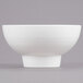 An American Metalcraft white porcelain footed bowl on a gray background.