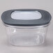 A Rubbermaid clear plastic square food storage container with a black lid.