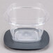A Rubbermaid clear plastic container with a lid on a black surface.