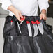 A chef holding a Victorinox 7-piece knife set with red handles.
