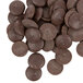 A pile of Ghirardelli 100% Cacao Unsweetened Chocolate Liquor Wafers.