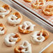 A tray of pretzels with white Ghirardelli coating.
