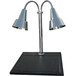 A Hanson Heat Lamps chrome carving station with two lamps over a black synthetic granite base.