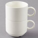 A stack of two white Arcoroc Daring porcelain coffee cups with handles.