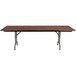 A Correll rectangular walnut folding table with brown legs and top.