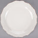 A white stoneware salad plate with a brown rim.