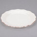 A white stoneware salad plate with a brown rim.