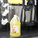A jug of Carnival King Pina Colada slush syrup next to a slushy machine.