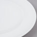 An Arcoroc white porcelain bread and butter plate with a white rim.