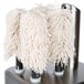 A Bar Maid glass polisher with white mop heads on a metal surface.
