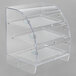 A clear acrylic Vollrath bakery case with three shelves and front doors.