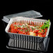 A Durable Packaging rectangular foil pan with clear dome lid containing food.