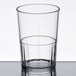 A clear Cambro plastic tumbler with a clear liquid inside.