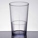 A clear plastic tumbler with a clear rim containing water.