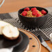 A 10 Strawberry Street Wazee Matte black stoneware cereal bowl filled with raspberries.