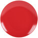 A close-up of a 10 Strawberry Street Wazee Matte red stoneware dinner plate with a white spot in the center.