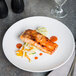 A piece of grilled salmon with vegetables on a 10 Strawberry Street Wazee Matte white stoneware dinner plate.