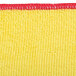A yellow and red Unger SmartColor microfiber cleaning cloth with a red trim.
