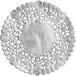 A white doily with a silver pattern on a white plate.