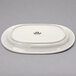 A white oval Tuxton china platter with an embossed rim.