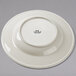 A white Tuxton china bowl with a round, embossed rim.