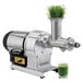 A Hamilton Beach wheatgrass juicer with a glass of green liquid in it.