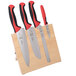 A Mercer Culinary Millennia Colors® knife set with red handles on a wooden block.