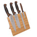 A Mercer Culinary Millennia Colors® knife set with brown handles on a bamboo magnetic board.