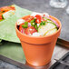 An American Metalcraft terra cotta melamine pot filled with salad and a tortilla wrap.