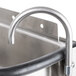 A Nemco stainless steel ice cream dipper well with a faucet.