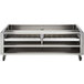 A Wolf stainless steel wood assist stand with two wood trays on a counter.