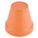 An orange plastic Terra Cotta pot with a lid on top.