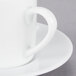 A close-up of a 10 Strawberry Street Classic White Porcelain Espresso Cup and Saucer.
