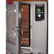A Blodgett pass-through electric combi oven with a door open and a rack of food inside.